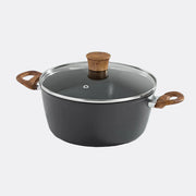 Black cookware pot with wooden handles and lid on a light grey background